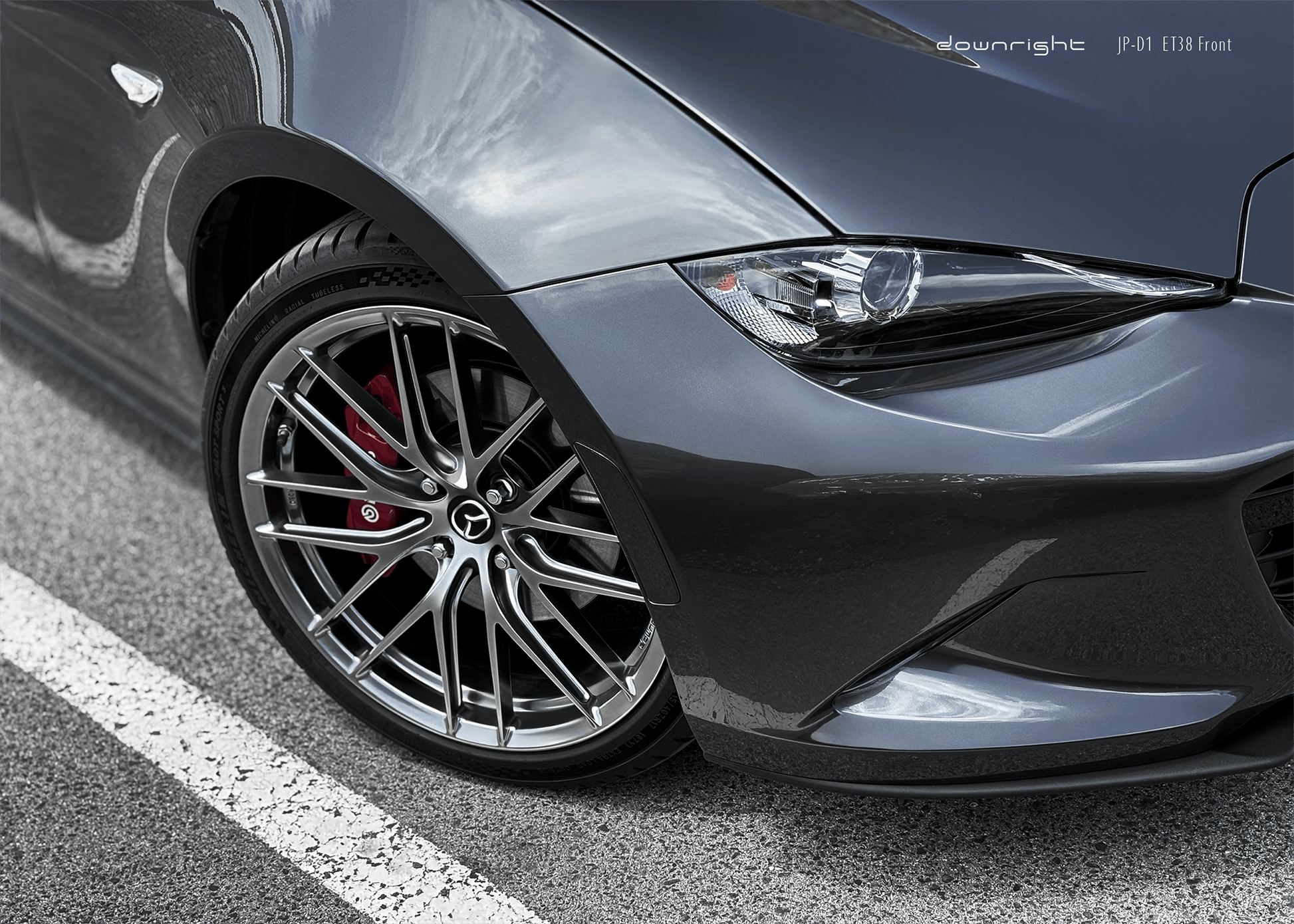 Close-up of a grey Mazda MX-5 ND with shinny wheels from downright parked on a mountain road of Grossglockner