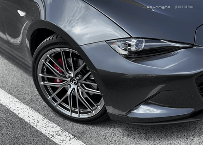 Close-up of a grey Mazda MX-5 ND with shinny wheels from downright parked on a mountain road of Grossglockner